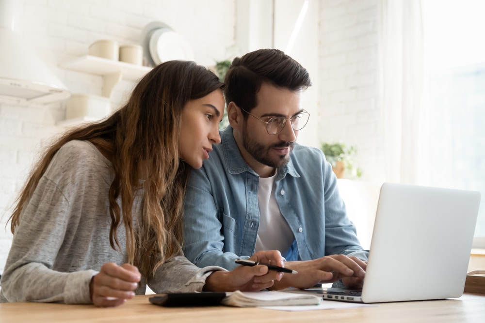 Focused young couple calculating bills