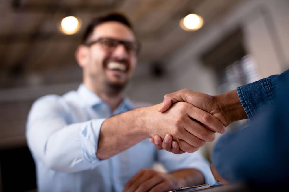 Business Owner Shaking Hands With Insurance Broker